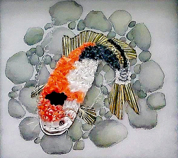 Embroidered art of a koi fish made from pebbles on a white background