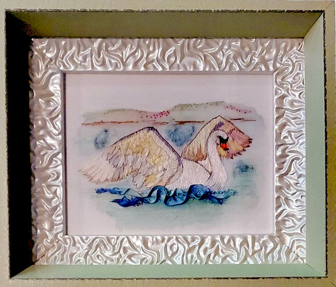 Framed artwork of a swan on water with decorative frame